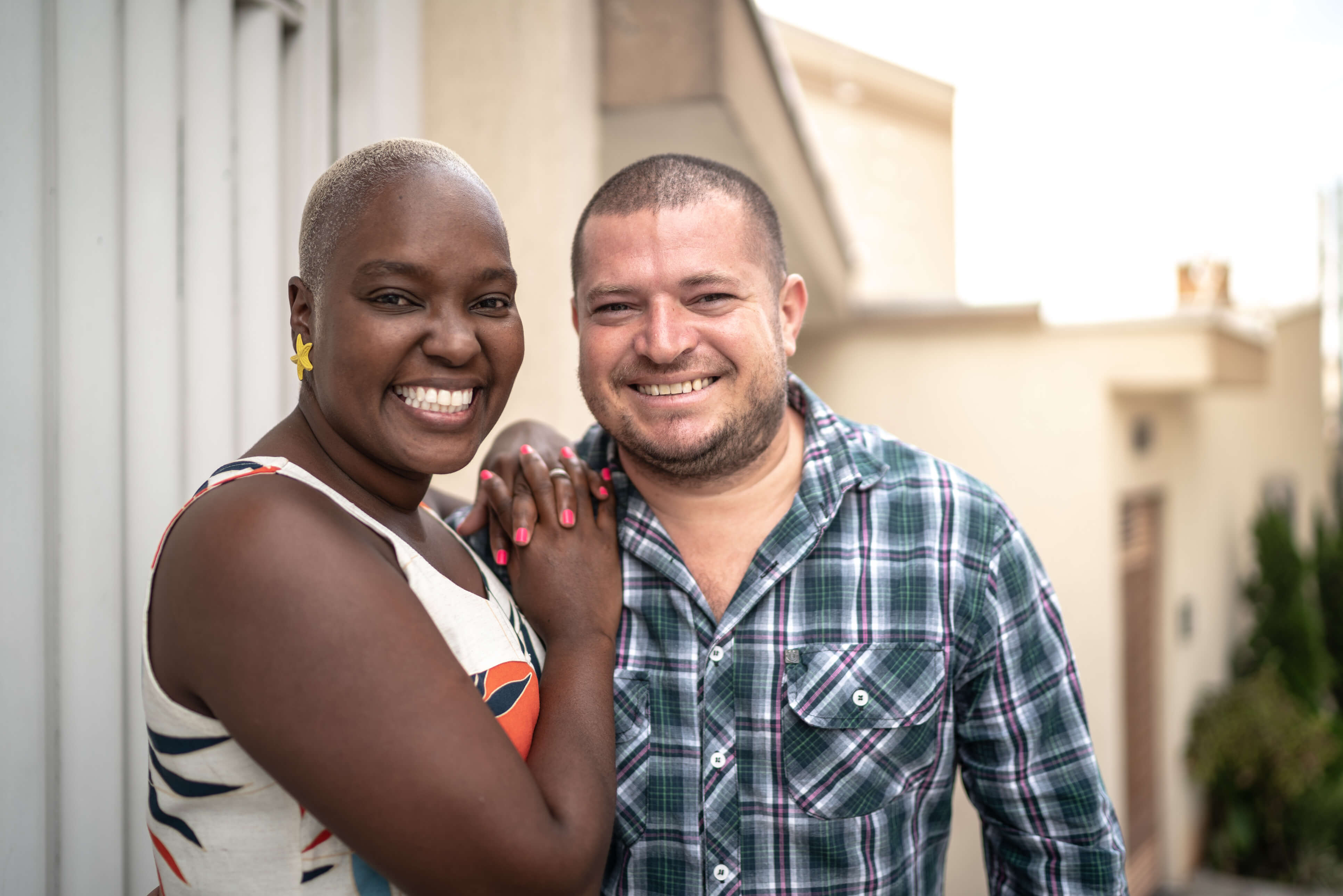 Black woman and white man smiling.